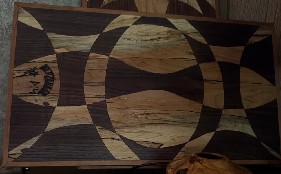 Large rectangular cutting board with an interlocking light-and-dark geometric pattern.