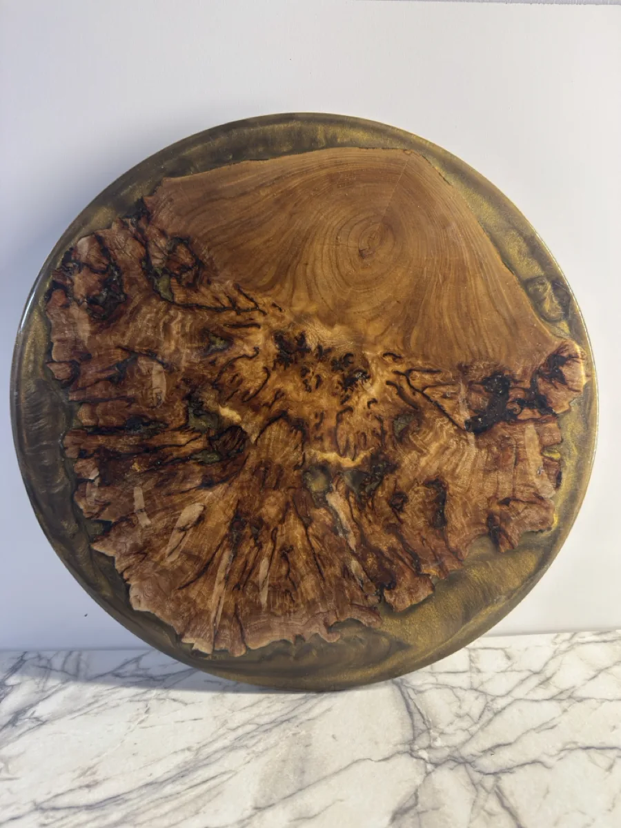 Round Lazy Susan with an irregular wood center and a dark outer ring.